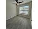 Bedroom features hardwood flooring, fan and window, and neutral paint at 8013 River Water Ct, Raleigh, NC 27616