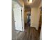 Hallway features neutral paint, hardwood flooring, with bedrooms and bathrooms just off the hall at 8013 River Water Ct, Raleigh, NC 27616