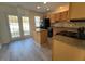 Modern kitchen with granite countertops, a central island, and backyard access at 8013 River Water Ct, Raleigh, NC 27616
