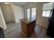 Bright kitchen island featuring granite countertops and access to the backyard at 8013 River Water Ct, Raleigh, NC 27616