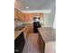 Charming kitchen featuring granite countertops, stainless steel appliances, and wood cabinets at 8013 River Water Ct, Raleigh, NC 27616
