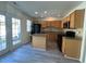 Open-concept kitchen with an island, stainless steel appliances, and access to the outdoor patio at 8013 River Water Ct, Raleigh, NC 27616