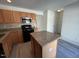 Well-lit kitchen features stainless steel appliances, granite countertops, and ample wood cabinetry at 8013 River Water Ct, Raleigh, NC 27616