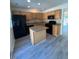 Spacious kitchen featuring stainless steel appliances and granite countertop island at 8013 River Water Ct, Raleigh, NC 27616
