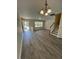 Open-concept living room boasts modern gray flooring and a bright, airy atmosphere at 8013 River Water Ct, Raleigh, NC 27616