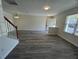 Spacious living room with wood staircase and a modern gray flooring at 8013 River Water Ct, Raleigh, NC 27616