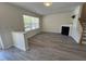 Cozy living area featuring a fireplace, large window, and modern gray flooring at 8013 River Water Ct, Raleigh, NC 27616