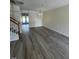 Bright living space with a modern staircase and modern gray flooring at 8013 River Water Ct, Raleigh, NC 27616