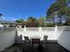 View of the enclosed backyard patio with table and chairs, ideal for outdoor relaxation at 8013 River Water Ct, Raleigh, NC 27616
