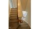 View of staircase with hardwood steps and a wooden banister leading to the upper level at 8013 River Water Ct, Raleigh, NC 27616