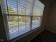 Bright window with blinds offering a view of the yard at 8013 River Water Ct, Raleigh, NC 27616