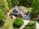 Aerial view of a beautiful home with lush landscaping and a long, winding driveway at 8480 Falkirk Ridge Ct, Wake Forest, NC 27587