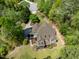 Drone's eye view of craftsman-style home with mature trees and back deck at 8480 Falkirk Ridge Ct, Wake Forest, NC 27587