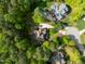 Expansive aerial view of home with mature trees and landscaping on a sunny day at 8480 Falkirk Ridge Ct, Wake Forest, NC 27587