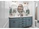 Bathroom featuring a double sink vanity with decorative mirrors and modern lighting fixtures at 8480 Falkirk Ridge Ct, Wake Forest, NC 27587