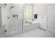 Elegant bathroom with a glass shower, a soaking tub, white subway tile, and marble flooring at 8480 Falkirk Ridge Ct, Wake Forest, NC 27587