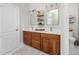 Bathroom featuring a double vanity with granite countertops, mirrors, lighting, and fixtures at 8480 Falkirk Ridge Ct, Wake Forest, NC 27587