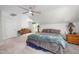 Bright bedroom with neutral carpet and bedding, slanted ceilings and a ceiling fan at 8480 Falkirk Ridge Ct, Wake Forest, NC 27587