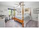 Bedroom features a ceiling fan, patterned bedding and a large window offering lots of natural light at 8480 Falkirk Ridge Ct, Wake Forest, NC 27587