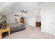 Bedroom with neutral carpet, slanted ceiling, window and simple wood desk at 8480 Falkirk Ridge Ct, Wake Forest, NC 27587