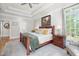 Sunlit bedroom showcasing a tray ceiling, wooden furniture, hardwood floors, and neutral paint at 8480 Falkirk Ridge Ct, Wake Forest, NC 27587