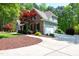 Charming two-story home featuring stone accents, attached garage, and mature trees at 8480 Falkirk Ridge Ct, Wake Forest, NC 27587
