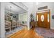 Welcoming foyer featuring a dining room, hardwood floors, and a decorative front door with lots of natural light at 8480 Falkirk Ridge Ct, Wake Forest, NC 27587