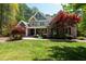 Charming stone and shake siding home with meticulous landscaping including a beautiful red Japanese maple at 8480 Falkirk Ridge Ct, Wake Forest, NC 27587
