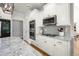 The well-equipped kitchen features stainless steel appliances, double ovens, and sleek, white cabinetry at 8480 Falkirk Ridge Ct, Wake Forest, NC 27587