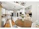 Stylish kitchen and breakfast nook featuring white cabinets, granite countertops, and an open layout at 8480 Falkirk Ridge Ct, Wake Forest, NC 27587