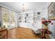Bright living room featuring custom built-ins, hardwood floors, and large windows with natural light at 8480 Falkirk Ridge Ct, Wake Forest, NC 27587