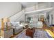 Spacious living room featuring hardwood floors, a staircase, and ample seating for entertaining guests at 8480 Falkirk Ridge Ct, Wake Forest, NC 27587