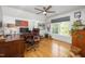 Office with hardwood floors, ceiling fan, window and a large wooden desk at 8480 Falkirk Ridge Ct, Wake Forest, NC 27587