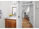 Cozy powder room showing a wooden vanity with an oval mirror and warm lighting at 8480 Falkirk Ridge Ct, Wake Forest, NC 27587