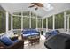 Relaxing screened porch with comfortable seating, a ceiling fan, and serene views of the wooded backyard at 8480 Falkirk Ridge Ct, Wake Forest, NC 27587