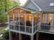 Relaxing screened-in porch with string lights, ceiling fan, and comfortable seating at 8480 Falkirk Ridge Ct, Wake Forest, NC 27587