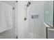 Close-up of a glass shower with a rainfall showerhead and tiled walls in a bathroom at 8480 Falkirk Ridge Ct, Wake Forest, NC 27587