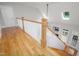Bright foyer with hardwood staircase and white railing leads into the living room with vaulted ceilings at 8480 Falkirk Ridge Ct, Wake Forest, NC 27587