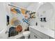 Well-lit bathroom with a patterned shower curtain, modern sink, and stylish decor, offering a refreshing space at 85 Sun Mdw Cir, Benson, NC 27504