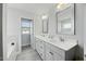 Bathroom featuring a double vanity with modern fixtures, bathtub, and shower, designed with a bright aesthetic at 85 Sun Mdw Cir, Benson, NC 27504