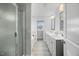 Bright bathroom featuring a double vanity, soaking tub, and shower with a glass door at 85 Sun Mdw Cir, Benson, NC 27504