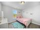Bright bedroom featuring natural light, neutral walls, a pink bedspread and butterfly themed decorations at 85 Sun Mdw Cir, Benson, NC 27504