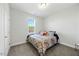 Cozy bedroom with a colorful patterned comforter and neutral-toned walls, creating a comfortable and inviting space at 85 Sun Mdw Cir, Benson, NC 27504