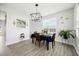 Modern dining area with table set for a meal and views into the kitchen at 85 Sun Mdw Cir, Benson, NC 27504