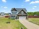 Charming two-story home boasts a manicured lawn, two-car garage, and inviting front porch at 85 Sun Mdw Cir, Benson, NC 27504