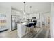 Modern kitchen features granite countertops, stainless steel appliances, and a central island with barstools at 85 Sun Mdw Cir, Benson, NC 27504
