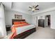 Inviting bedroom with a bed, dresser, neutral carpet and walls, ceiling fan and a closet door visible at 85 Sun Mdw Cir, Benson, NC 27504
