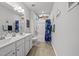 Bathroom featuring a double sink vanity, a shower tub, and a shark themed wall decor, creating a fun space at 8812 Green Arbor Ct, Wake Forest, NC 27587
