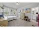 Bright bedroom featuring two windows, ensuite bathroom, dresser and space for artwork on the wall at 8812 Green Arbor Ct, Wake Forest, NC 27587
