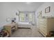 Bright bedroom featuring two windows, dresser, study desk and space for artwork on the wall at 8812 Green Arbor Ct, Wake Forest, NC 27587